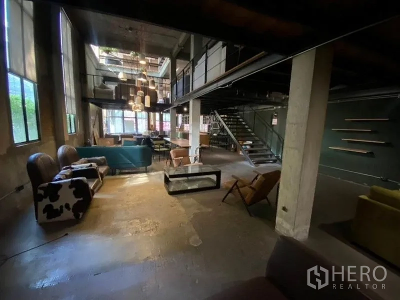 Retail Space for rent in Bang Na, Bangkok - Industrial lounge with high ceiling, statement lights and stairs