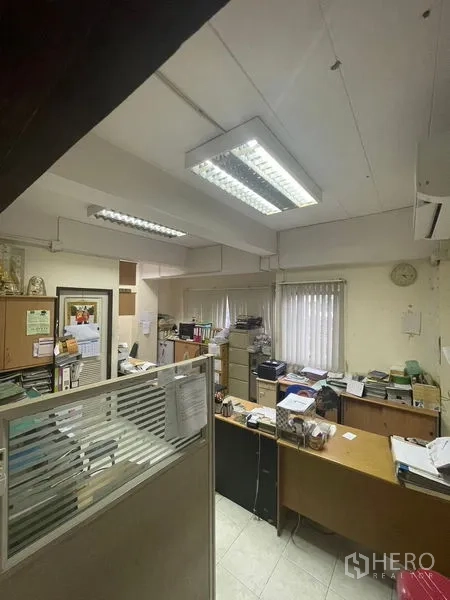 Home Office for sale in Yan Nawa, Bangkok - Office room with desks, filing cabinets, and bright ceiling lights.