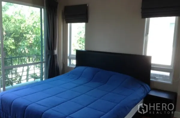 Detached House for rent in Saphan Sung, Bangkok - Corner bedroom with large bed, double windows and leafy view