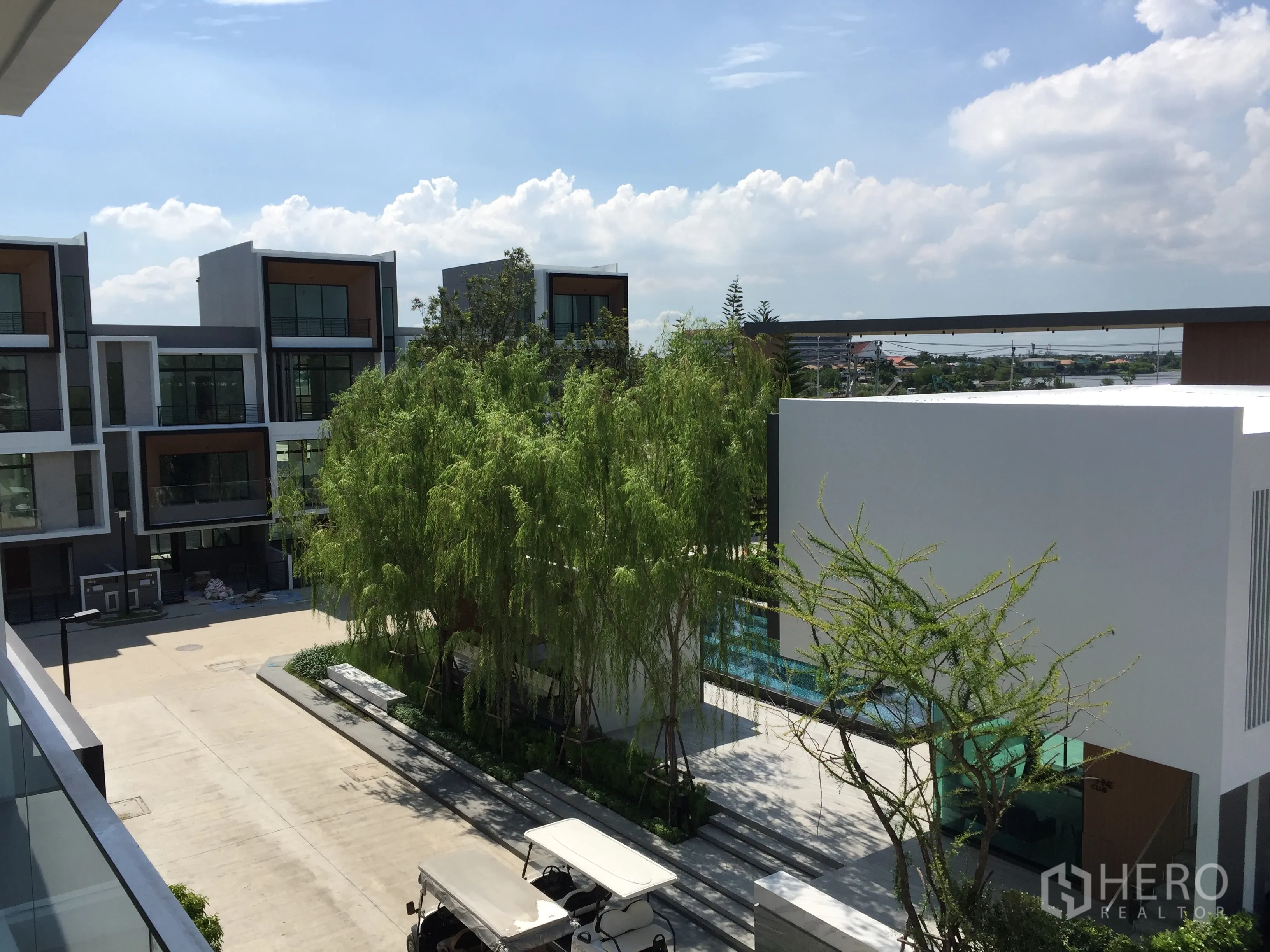 Townhouse for rent in Saphan Sung, Bangkok - View from an upper balcony of contemporary townhouses, clubhouse and pool.