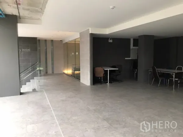 零售空间 出租在Khlong Toei, Bangkok - 大堂层零售区，整面玻璃、楼梯与灰色地砖。