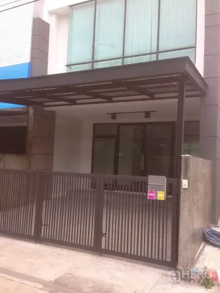 สำนักงานที่บ้าน ให้เช่าในBang Phli, Samut Prakan - ด้านหน้าอาคารโฮมออฟฟิศสไตล์โมเดิร์น กระจกเต็มบาน พร้อมประตูรั้วและที่จอดรถมีหลังคา