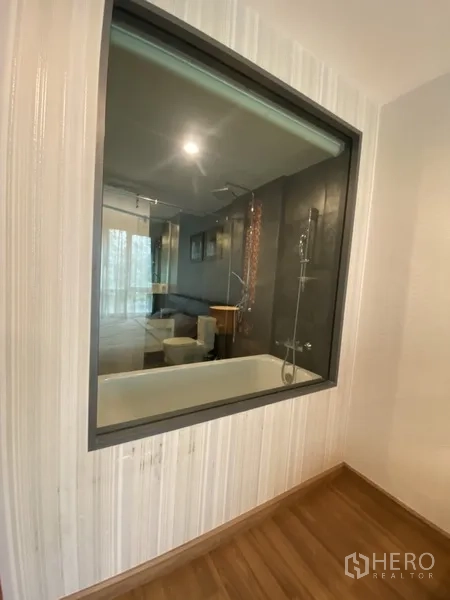 Condominium for rent in Watthana, Bangkok - Bathroom with glass partition to the bedroom, bathtub and rainfall shower.