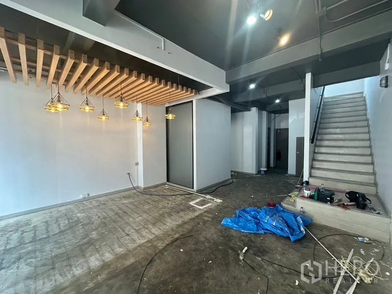 Home Office for rent - Ground floor workspace under renovation with wood slat ceiling and staircase.