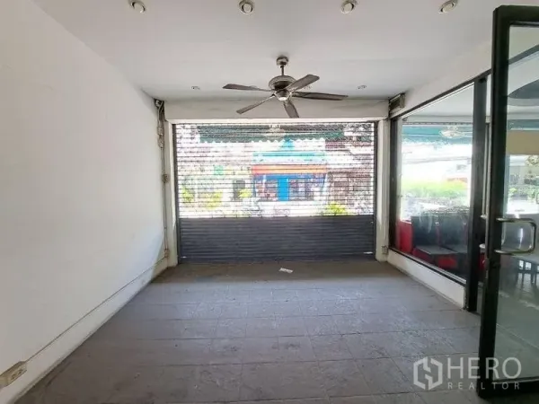 Retail Space for rent - Street‑facing shopfront with large windows and a security roller shutter.