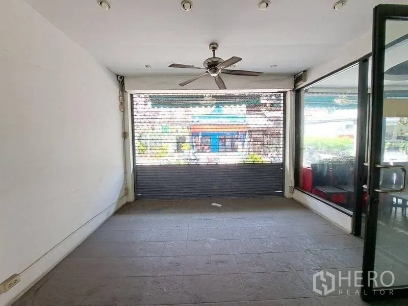 Retail Space for rent - Street‑facing shopfront with large windows and a security roller shutter.