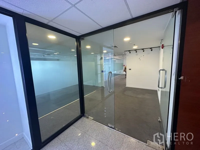 Office Space for rent - Entrance with double glass doors leading into carpeted office suite.