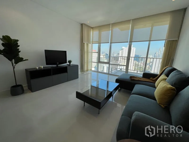 คอนโด ให้เช่าหรือขายในWatthana, Bangkok - ตู้ทีวีตรงข้ามโซฟา ในห้องรับแขกสว่างพร้อมหน้าต่างสูงเผยวิวเมืองพาโนรามา