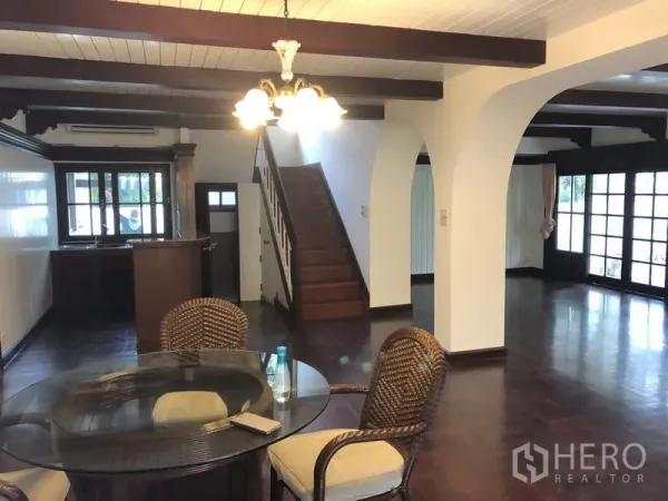 บ้าน ให้เช่าในKhan Na Yao, Bangkok - พื้นที่รับประทานอาหารแบบโอเพ่นพร้อมโคมไฟ ซุ้มโค้ง บันได และประตูออกสวน.