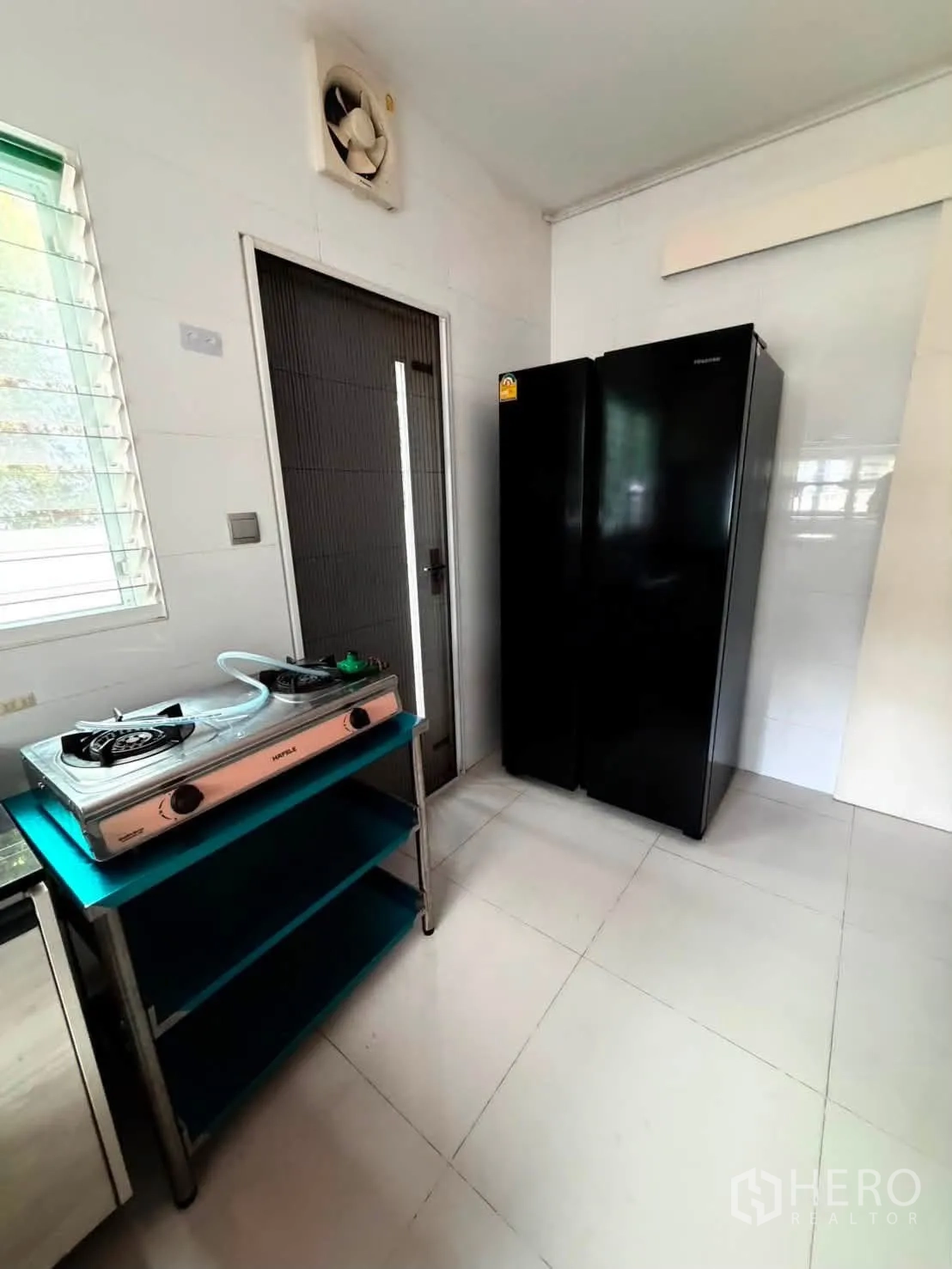 Detached House for rent in Bang Phli, Samut Prakan - Service kitchen area with gas stove on rack and double-door fridge.
