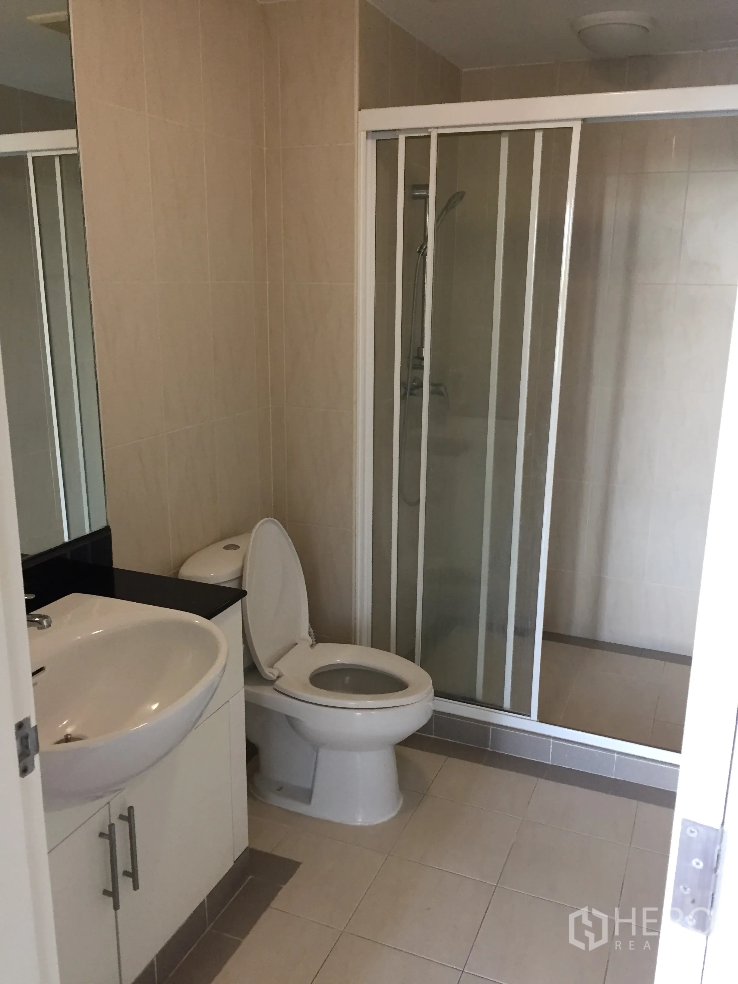 คอนโด ให้เช่าในWatthana, Bangkok - ห้องน้ำปูกระเบื้องพร้อมอ่างล้างหน้า โถสุขภัณฑ์ และตู้กระจกกั้นอาบน้ำ