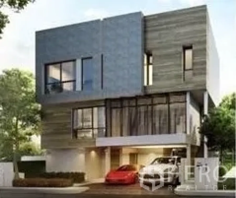 Detached House for rent or sale in Huai Khwang, Bangkok - Contemporary three-storey detached house exterior with carport and expansive windows.