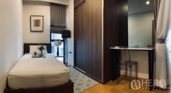 Condominium for rent in Watthana, Bangkok - Cozy second bedroom with single bed, built-in wardrobe and a study nook by the window.