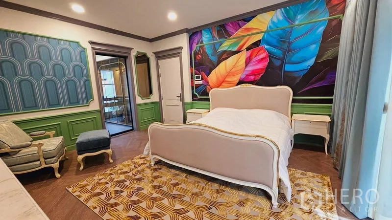 Detached House for rent or sale in Saphan Sung, Bangkok - Bedroom with upholstered bed and vibrant tropical mural feature wall.