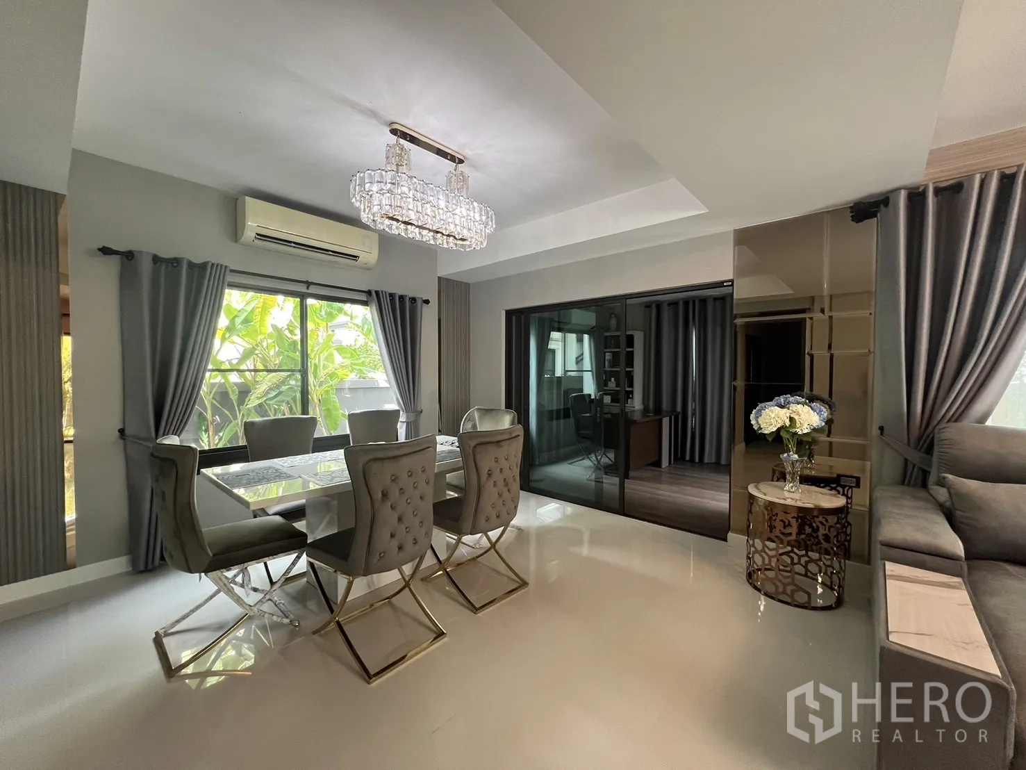 Detached House for rent in Bang Phli, Samut Prakan - Bright dining area with six upholstered chairs and a crystal chandelier.