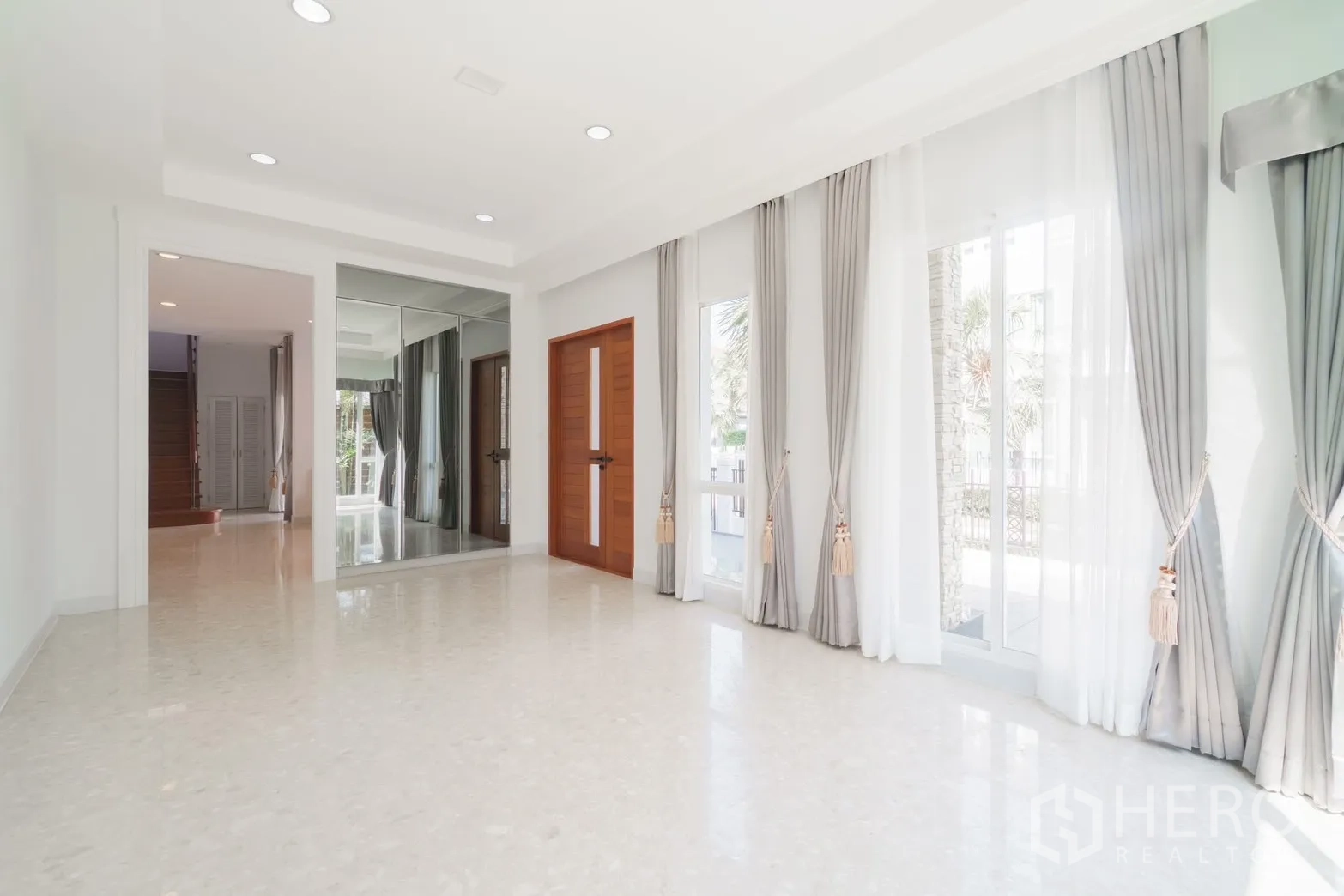 Detached House for rent or sale in Saphan Sung, Bangkok - Bright foyer or living space with full-height windows and drapes.