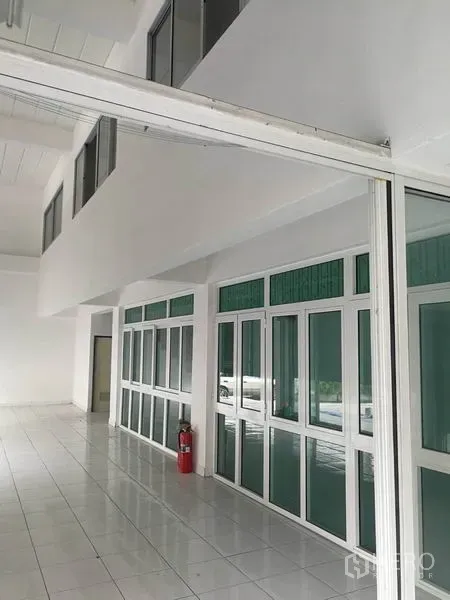Warehouse for rent in Bang Phli, Samut Prakan - Bright glass-partitioned office area with white tiled floors inside the warehouse.