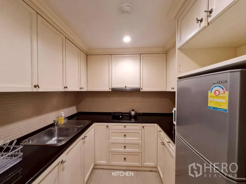 พื้นที่ขายปลีก ให้เช่าในWatthana, Bangkok - ครัวบริการขนาดกะทัดรัด ตู้สีครีม เคาน์เตอร์หินสีดำ