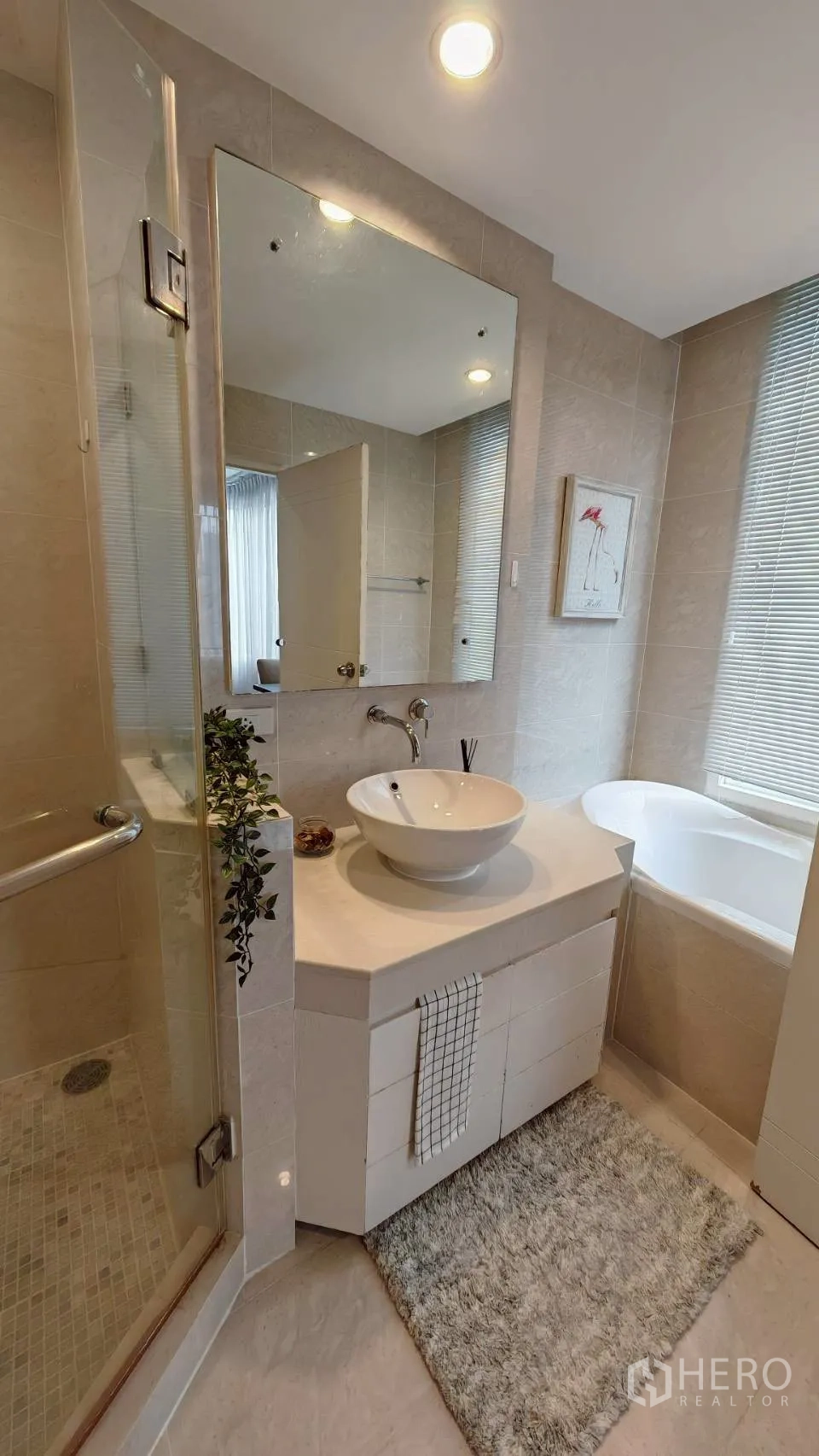 Condominium for rent in Khlong Toei, Bangkok - Bathroom with vessel sink, separate glass shower and a soaking tub by the window.