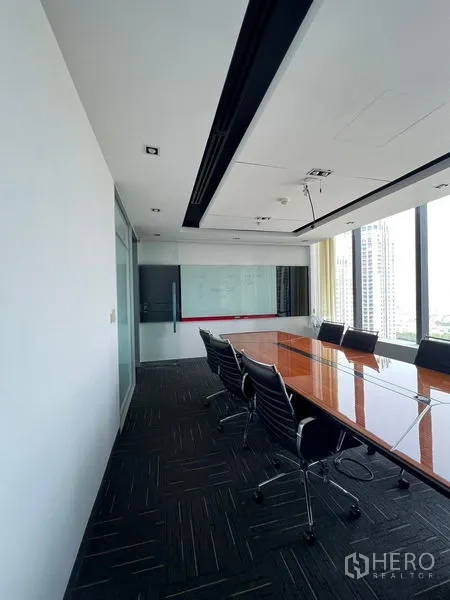 Office Space for rent in Huai Khwang, Bangkok - Side view of the boardroom with a whiteboard wall and city‑facing windows.