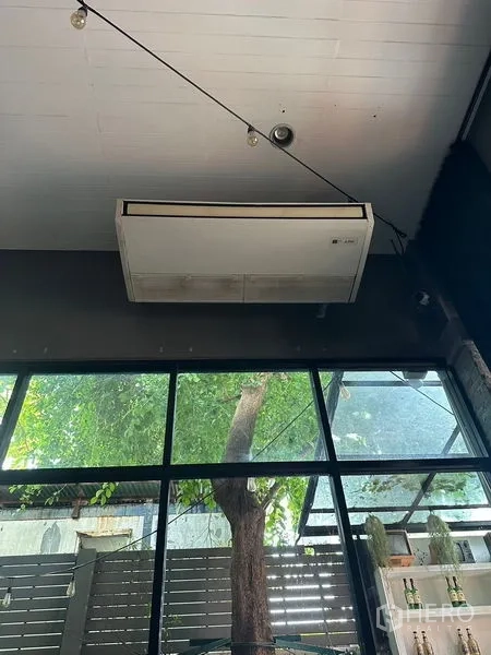 Retail Space for rent in Suan Luang, Bangkok - Ceiling-mounted air-conditioning unit above a glass wall with trees outside.