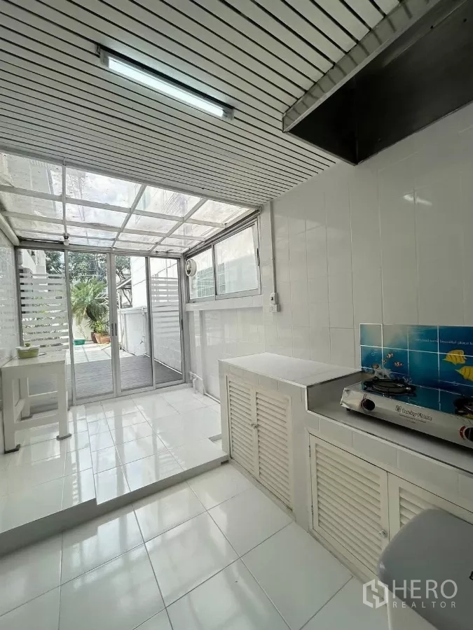 Detached House for rent in Suan Luang, Bangkok - Enclosed Thai kitchen with white tiles opening to the deck.