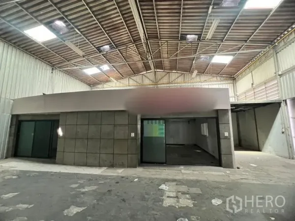 Warehouse for rent in Suan Luang, Bangkok - Front of the internal office block inside the warehouse with sliding glass doors.