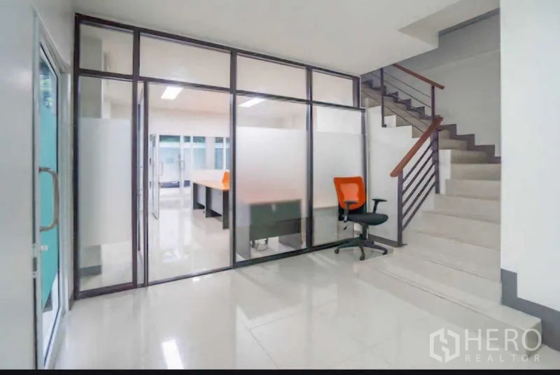 Home Office for rent or sale in Lat Krabang, Bangkok - Entry hall with glass wall revealing workstations and staircase.
