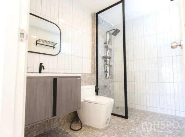 Detached House for sale in Wang Thonglang, Bangkok - Contemporary bathroom with glass walk-in shower, rainfall head and floating vanity with mirror.