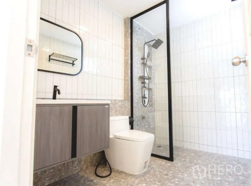 Detached House for sale in Wang Thonglang, Bangkok - Contemporary bathroom with glass walk-in shower, rainfall head and floating vanity with mirror.