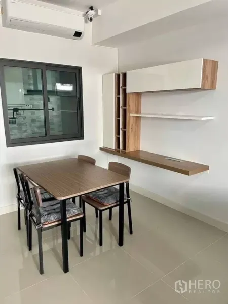 Townhouse for rent in Bang Phli, Samut Prakan - Close-up of the dining nook with air conditioner and a window toward the kitchen.