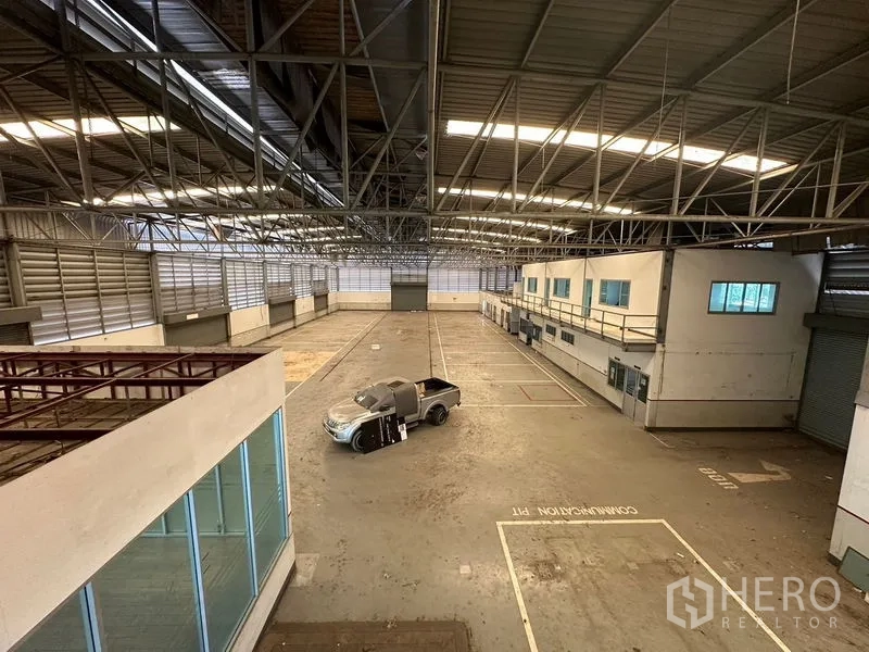 Showroom for rent or sale in Lam Luk Ka, Pathum Thani - Elevated view across the warehouse floor and internal offices.