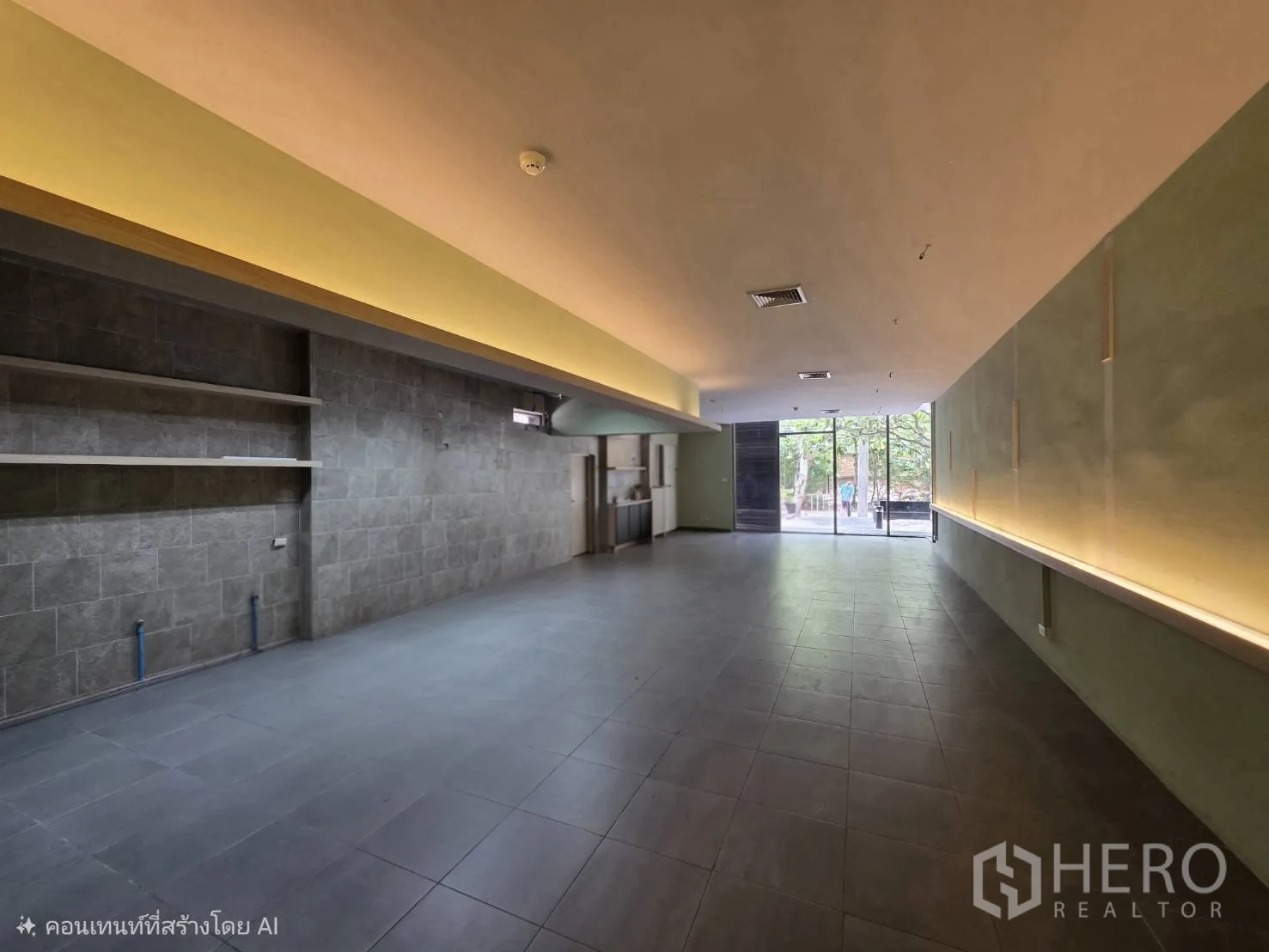 Retail Space for rent in Khlong Toei, Bangkok - Long retail hall facing large front windows with display shelving.