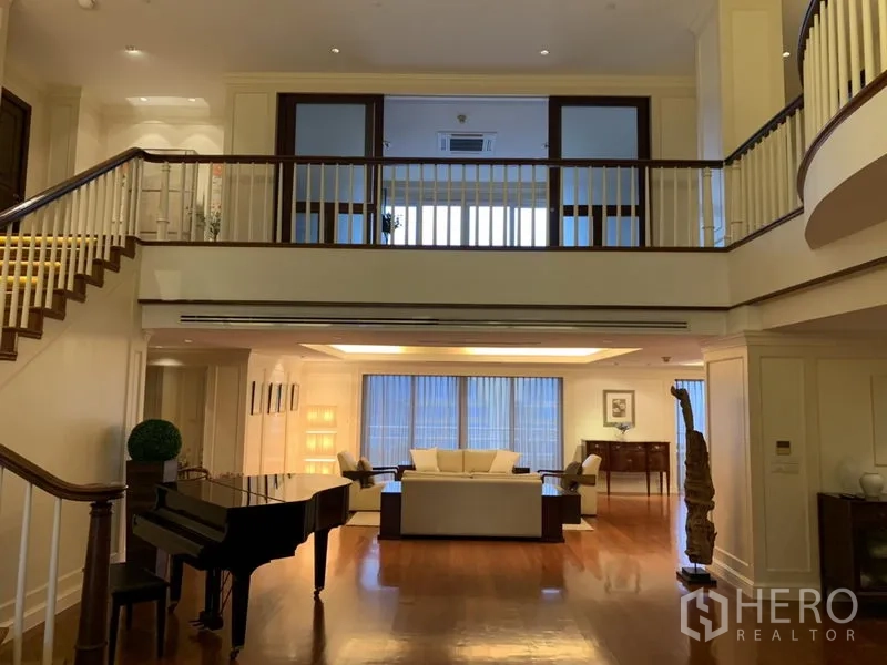 Condominium for rent or sale in Watthana, Bangkok - Mezzanine gallery overlooking a large living area with seating and a grand piano.