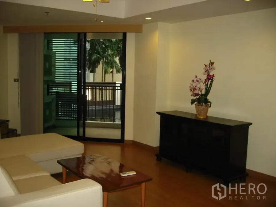 คอนโด ให้เช่าในWatthana, Bangkok - ห้องนั่งเล่นสว่างพร้อมโซฟา โต๊ะกลาง และประตูออกสู่ระเบียงวิวสระ