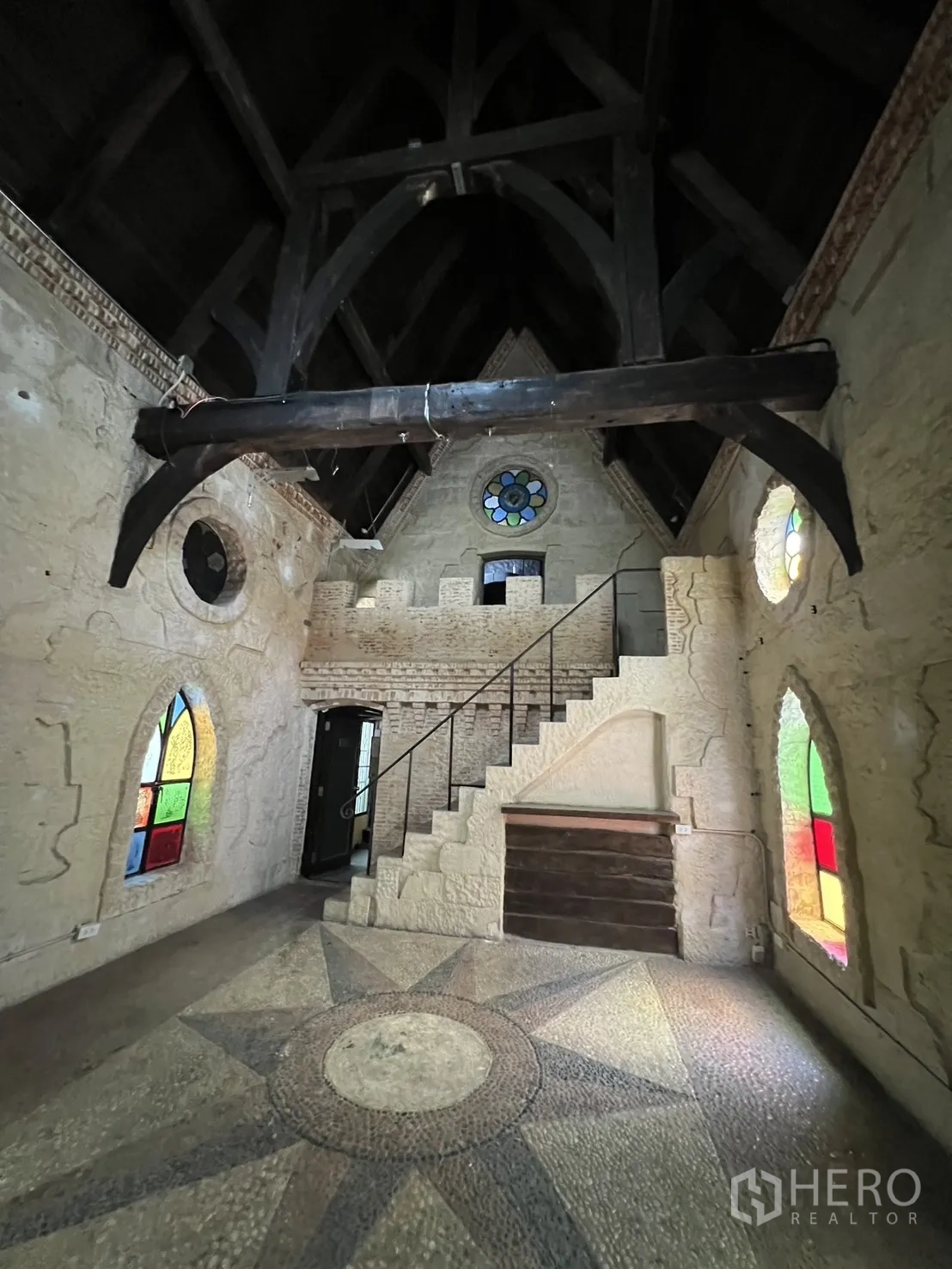 零售空间 出租在Watthana, Bangkok - 挑高双层门厅，木梁、石阶与罗盘图案马赛克地面。