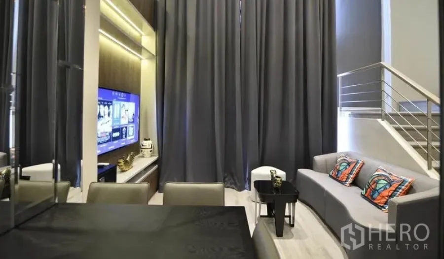 公寓 出租在Huai Khwang, Bangkok - 挑高客厅配灰色窗帘、沙发、电视墙和餐桌