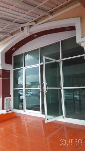 Office Space for rent in Bueng Kum, Bangkok - Exterior storefront with full-height glass doors under a covered terrace with orange tiles.