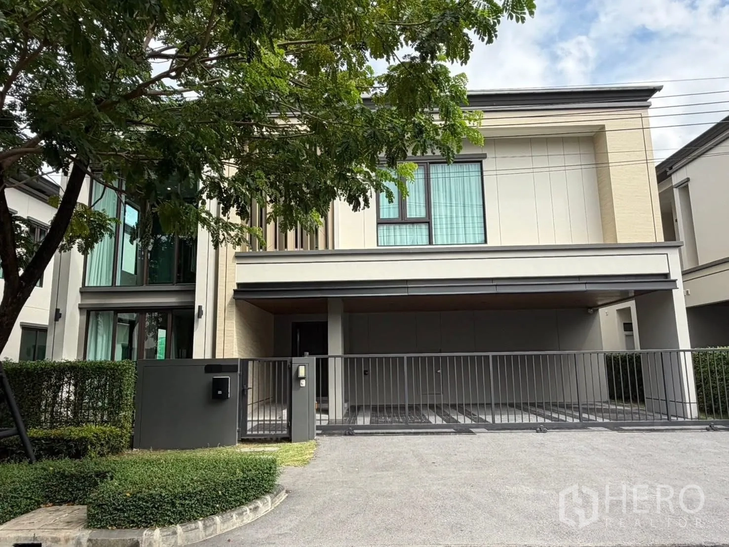 Detached House for rent in Bang Phli, Samut Prakan - Modern two-storey detached house exterior with gated driveway, carport and large windows.