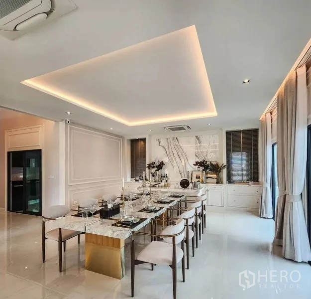 Detached House for sale in Bang Phli, Samut Prakan - Sophisticated dining room with marble-top table and ambient ceiling lights.