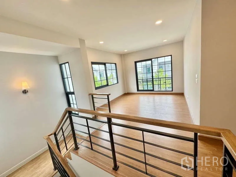 Detached House for sale in Bang Phli, Samut Prakan - Staircase landing opening to a spacious multipurpose room with big windows.