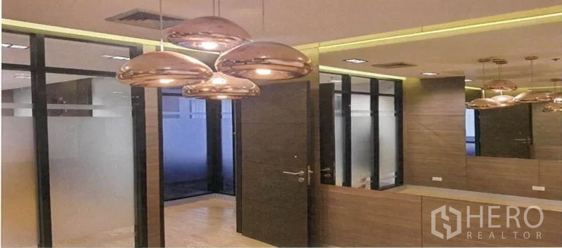 Office Space for rent in Bang Rak, Bangkok - Modern meeting area with bronze pendant lights, wood wall panels and glass partitions.