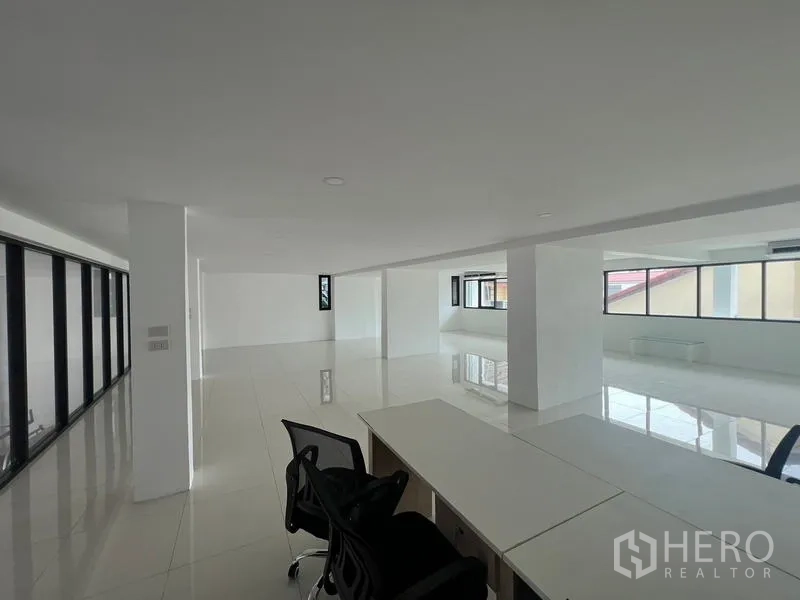 Office Space for rent or sale in Wang Thonglang, Bangkok - Open-plan office floor with white tiles, desks and large windows.