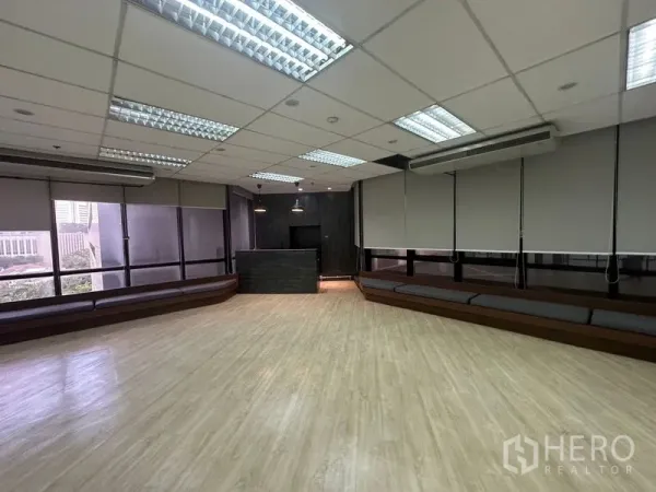 办公空间 出租在Din Daeng, Bangkok - 宽敞开放空间，木地板、窗边长座与吊顶灯。