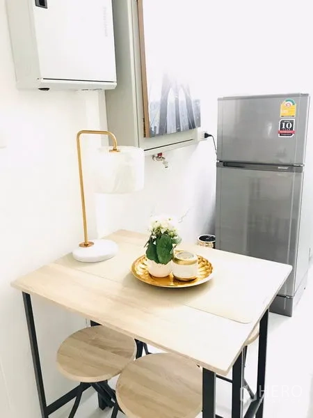 Retail Space for rent in Khlong Toei, Bangkok - Small dining nook with wooden table, stools and stainless steel refrigerator.