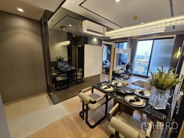 Condominium for rent - Dining table set under linear chandelier beside living room and balcony.