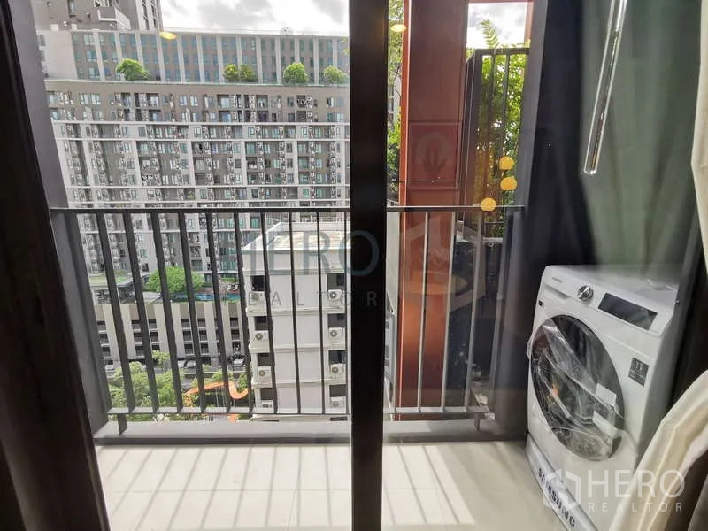 Condominium for rent or sale - Small balcony with city view and washing machine enclosure.