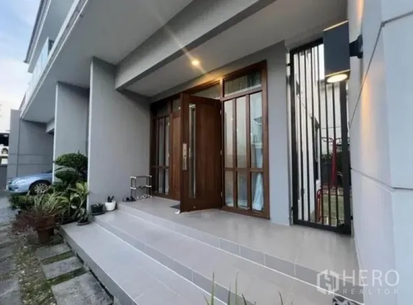 独立式住宅 出租 - 黄昏时的入户露台，铺设台阶与绿植，实木大门稳固。