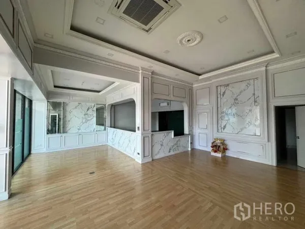 Office Space for rent in Prawet, Bangkok - Bright reception-style office with marble accents, coffered ceiling, wood floors and large glass frontage.
