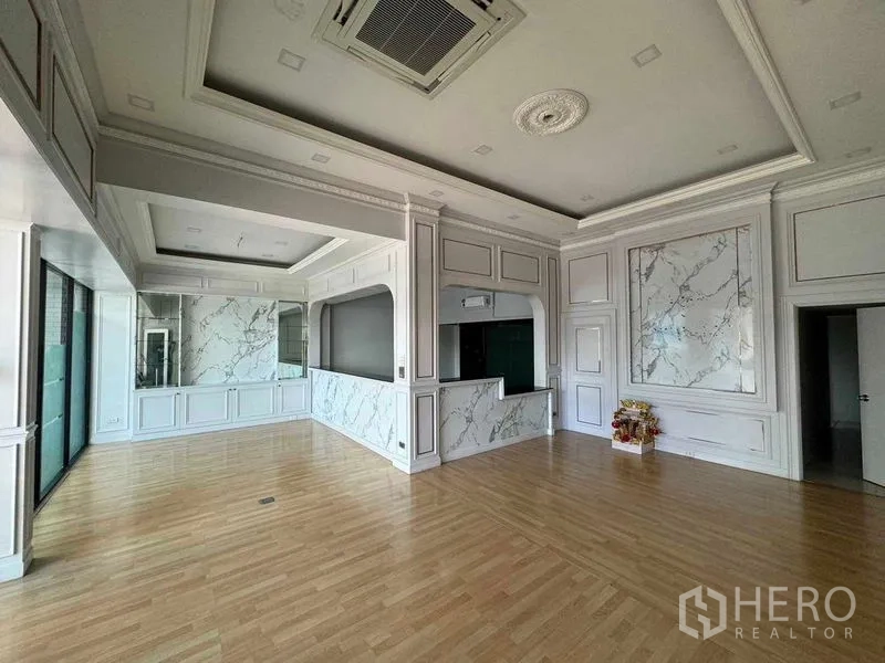 Office Space for rent in Prawet, Bangkok - Bright reception-style office with marble accents, coffered ceiling, wood floors and large glass frontage.